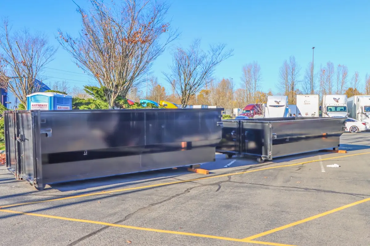 Professional dumpster rental service with roll-off container on residential driveway in Dalton